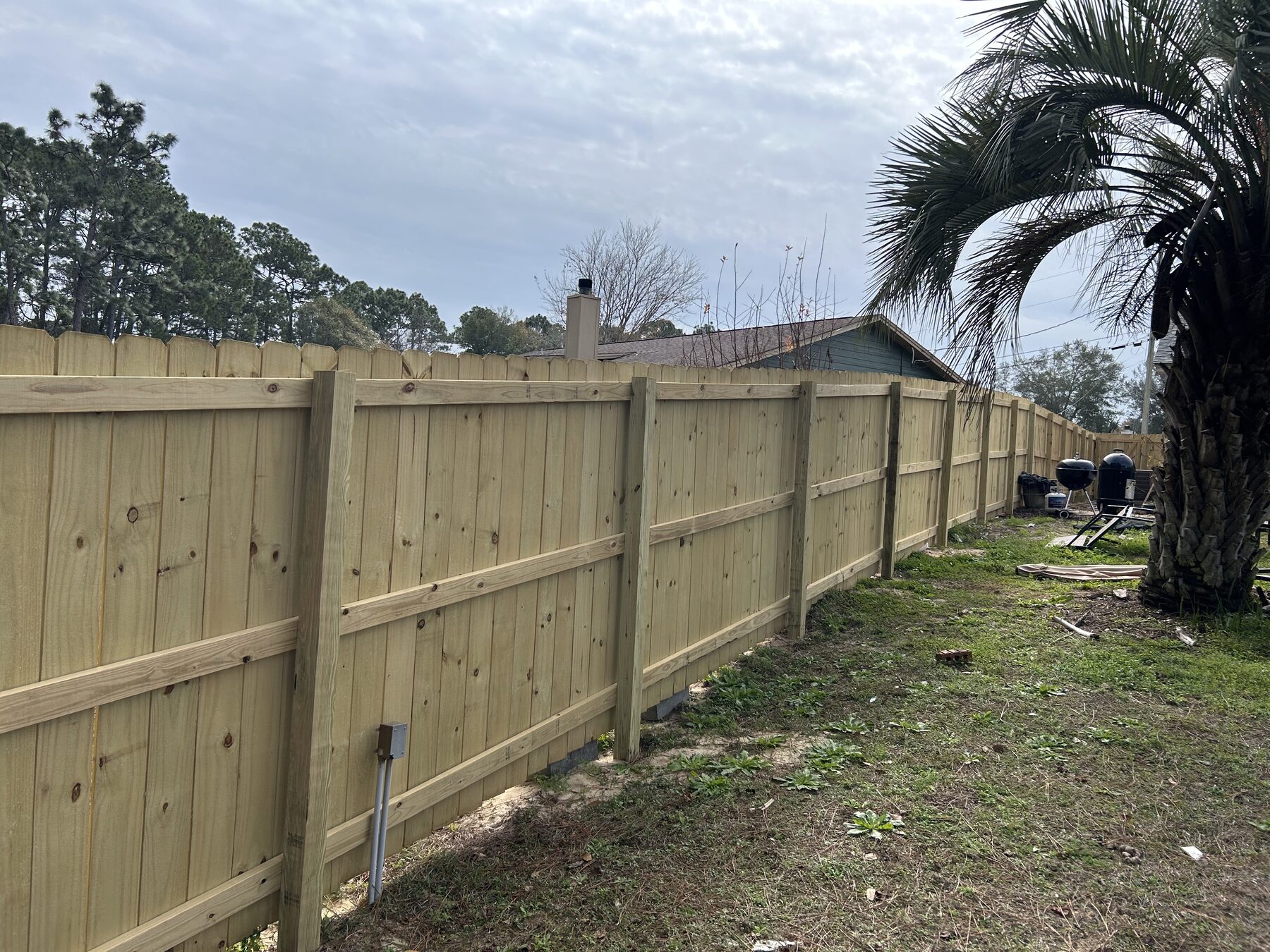 Long pressure-treated wood privacy fence built by Barberi Fence Company in Pensacola